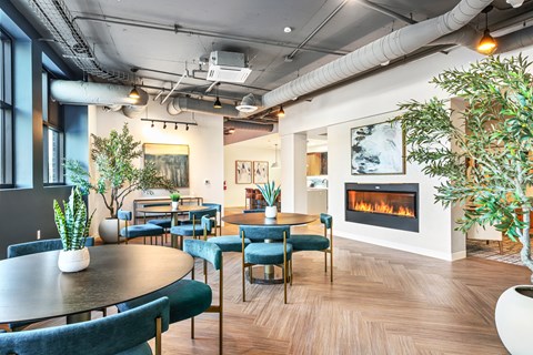 a dining room with tables and chairs and a fireplace